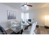 Bright dining room with modern table, seating for six and a ceiling fan at 1322 W Flower St, Phoenix, AZ 85013