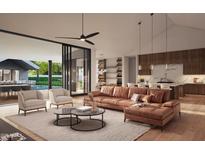 Bright living room featuring an open layout, modern furniture, and seamless indoor-outdoor flow to the pool area at 13402 N 79Th St, Scottsdale, AZ 85260