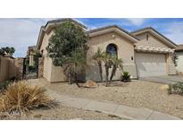 Charming single-story home with low-maintenance desert landscaping and a two-car garage at 14380 W Monte Vista Rd, Goodyear, AZ 85395