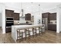 Stunning kitchen boasts a spacious island, stainless steel appliances, and modern finishes at 14789 W Lariat Ln, Surprise, AZ 85387