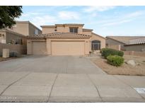 Charming two-story home featuring a three-car garage and low maintenance desert landscaping in a residential neighborhood at 15421 S 16Th Dr, Phoenix, AZ 85045