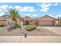 Lovely single-Gathering home featuring desert landscaping, a two-car garage, and a lush, green lawn at 15534 W Big Sky Dr, Surprise, AZ 85374