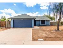 Front exterior with a gray door, gravel lawn, and concrete driveway at 161 S Maple St, Chandler, AZ 85226
