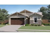 Charming single-story home featuring a stone facade accent, a two-car garage, and manicured landscaping at 17349 W Smoketree Dr, Surprise, AZ 85387