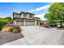 Charming two-story home with a three car garage, landscaped yard, and beautiful desert vegetation at 19242 W Pasadena Ave, Litchfield Park, AZ 85340