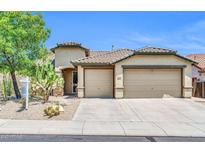 Inviting single-story home showcasing a well-kept xeriscaped front yard and a convenient three-car garage at 2405 W Memorial Dr, Anthem, AZ 85086