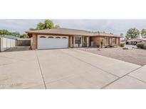 Charming single-story brick home with a spacious driveway and two-car garage at 2605 E Fountain St, Mesa, AZ 85213