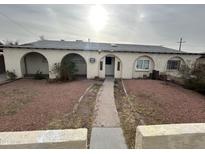 Charming home featuring arched entryways and desert landscaping, creating a unique curb appeal at 3062 N 42Nd Ave, Phoenix, AZ 85019