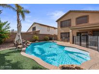 Beautiful backyard pool with rock waterfall feature and well maintained turf and landscaping at 4323 E Dublin St, Gilbert, AZ 85295