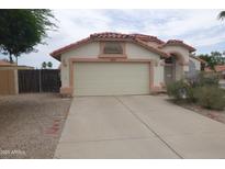 Charming single-story home featuring a tile roof and a spacious two car garage at 625 N Granite N St, Gilbert, AZ 85234