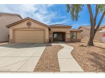 Charming single-story home with a two-car garage, desert landscaping, and a curved walkway to the front door at 681 W Racine Loop, Casa Grande, AZ 85122