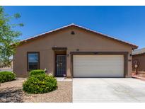 Charming single-story home featuring a two-car garage and low maintenance desert landscaping in the front yard at 8012 S Magic Dr, Casa Grande, AZ 85193