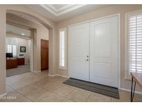 Welcoming foyer with tiled floor, arched entryway, and double front doors with window shutters for added privacy at 18226 W Stinson Dr, Surprise, AZ 85374