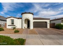 Charming single-story home featuring a unique turret entry, tile roof, and attached two-car garage at 23503 S 228Th Pl, Queen Creek, AZ 85142