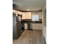 Bright kitchen featuring stainless steel appliances and ample cabinet space at 286 W Palomino Dr # 105, Chandler, AZ 85225