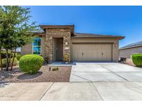 Charming single-story home featuring a stone-accented entrance and a two-car garage at 41825 W Mesquite Rd, Maricopa, AZ 85138