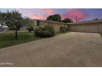 Single story home with a well manicured yard and large driveway at 4533 W Cavalier Dr, Glendale, AZ 85301