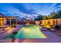 Sparkling pool surrounded by desert landscaping and block wall fencing providing a private backyard oasis at 490 W Encinas St, Gilbert, AZ 85233