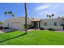 Charming single story home with a lush green lawn and a two car garage at 629 E State Ave, Phoenix, AZ 85020