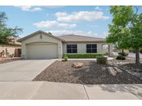 Charming single-story home with a well-maintained front yard and a two-car garage at 6439 W Kristal Way, Glendale, AZ 85308