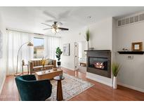 Inviting living room with a modern fireplace, stylish furniture, and a ceiling fan for comfort at 6900 E Princess Dr # 2247, Phoenix, AZ 85054