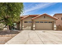 Charming single-story home with a neutral color scheme, well-maintained landscaping, and three-car garage at 726 E Heather Dr, San Tan Valley, AZ 85140