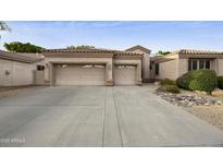 Charming single-story home with a two-car garage and desert landscaping at 7262 W Firebird Dr, Glendale, AZ 85308