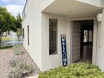 Inviting home exterior with a charming welcome sign near the front door and views of the water fountain at 7272 E Gainey Ranch Rd # 122, Scottsdale, AZ 85258
