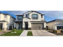 Charming two-story home with a two-car garage, manicured lawn, and modern architectural details at 10351 W Deanna Dr, Peoria, AZ 85382
