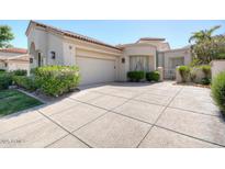 Charming single-story home with a two-car garage, beautiful landscaping, and tile roof at 10458 N 101St St, Scottsdale, AZ 85258
