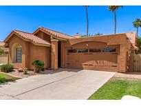 Charming home featuring a red tile roof and two-car garage at 1214 W Sand Dune Dr, Gilbert, AZ 85233