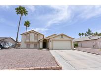 Charming two-story home featuring a well-maintained front yard and attached two-car garage at 1219 E Avenida Isabela --, Casa Grande, AZ 85122