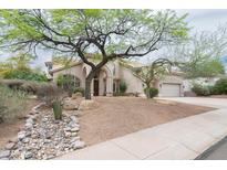Charming single-story home boasts mature landscaping and a desert-style rock garden feature at 2709 E Vista Dr, Phoenix, AZ 85032
