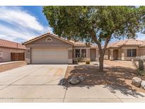 Charming single-story home featuring a two-car garage, desert landscaping, and a tiled roof at 2710 S Shelby --, Mesa, AZ 85209