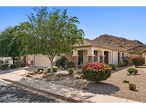 Charming single-story home featuring a well-manicured yard, desert landscaping and a two car garage at 31716 N Poncho Ln, San Tan Valley, AZ 85143