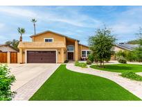 Charming two-story home with a well-manicured front yard and a two-car garage at 3358 W Sandra Ter, Phoenix, AZ 85053