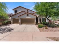 Charming two-story home with a three-car garage, desert landscaping, and a well-maintained front yard at 35746 N 32Nd Ln, Phoenix, AZ 85086