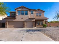 Charming two-story home with a three-car garage and a well-maintained front yard at 4187 N 298Th Ln, Buckeye, AZ 85396