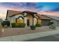 Charming single-story home featuring desert landscaping, a two-car garage, and a welcoming front porch at 4329 W Electra Ln, Glendale, AZ 85310