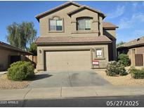 Two story home showcasing desert landscaping, attached two car garage and tile roof at 43455 W Chisholm Dr, Maricopa, AZ 85138