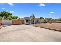 Charming single-story home featuring an expansive driveway and distinctive architectural details at 439 N Cherry --, Mesa, AZ 85201
