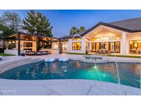 Backyard oasis with a pool, spa, and outdoor kitchen, perfect for entertaining at 5 E Oakwood Hills Dr, Chandler, AZ 85248