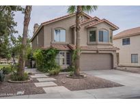 Charming two-story home featuring a two-car garage, desert landscaping, and a red tile roof at 533 N Cobblestone St, Gilbert, AZ 85234