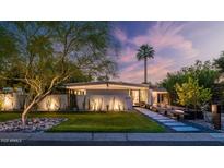 Inviting single-story home with lush front lawn and xeriscaping under a dramatic dusk sky at 5714 N 11Th St, Phoenix, AZ 85014