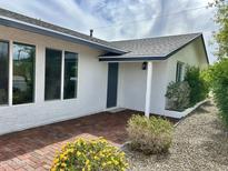 Welcoming front entrance with red brick pavers and freshly painted exterior, landscaping and modern windows at 6923 E Hubbell St, Scottsdale, AZ 85257