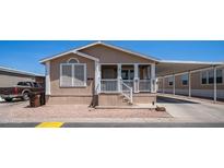 Tan home with a covered porch and carport provides covered parking at 9431 E Coralbell Ave # 6, Mesa, AZ 85208