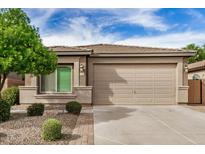 Charming single-story home features a well-maintained yard with attractive landscaping and a two-car garage at 1008 W Heatherwood St, San Tan Valley, AZ 85140