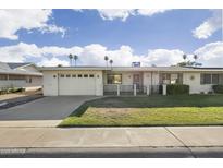 Charming single-story home featuring a well-maintained lawn, two-car garage, and inviting curb appeal at 10222 N 105Th Dr, Sun City, AZ 85351