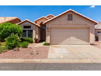 Charming single-story home featuring a well-maintained yard and two car garage at 11622 W Buck Mountain Ct, Surprise, AZ 85378