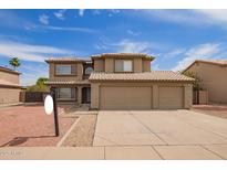 Attractive two-story home boasts a tile roof, spacious three-car garage and low maintenance desert landscaping at 12325 W Canterbury Dr, El Mirage, AZ 85335